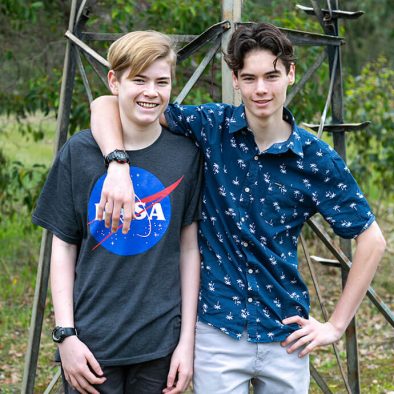 two teenage boys standing together and smiling. These are the owners 2 sons.