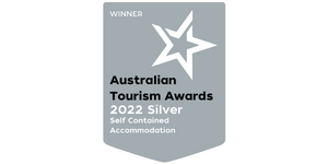 An image of a badge showing Tree Chalets Silver Medal win for self catering accommodation in the 2022 Australian Tourism Awards
