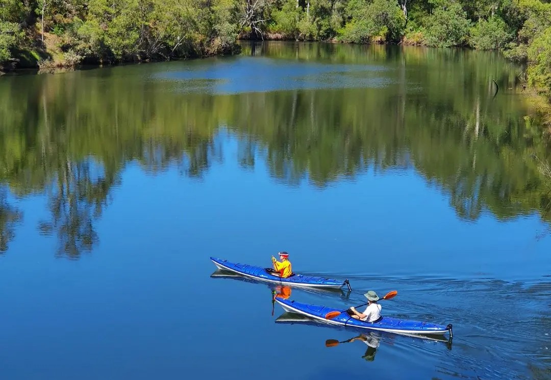 Canoeists paddling on the Blackwood river Chapman Pool